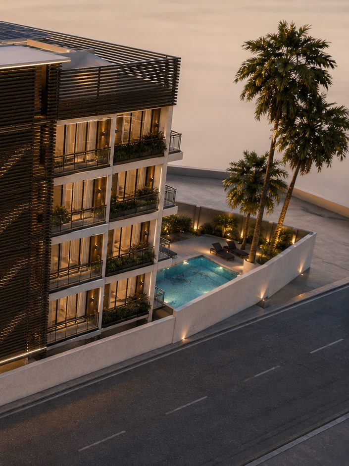 The pool terrace beside Casabella Tower at sunset, with loungers, planting and palms set between the building and the street.